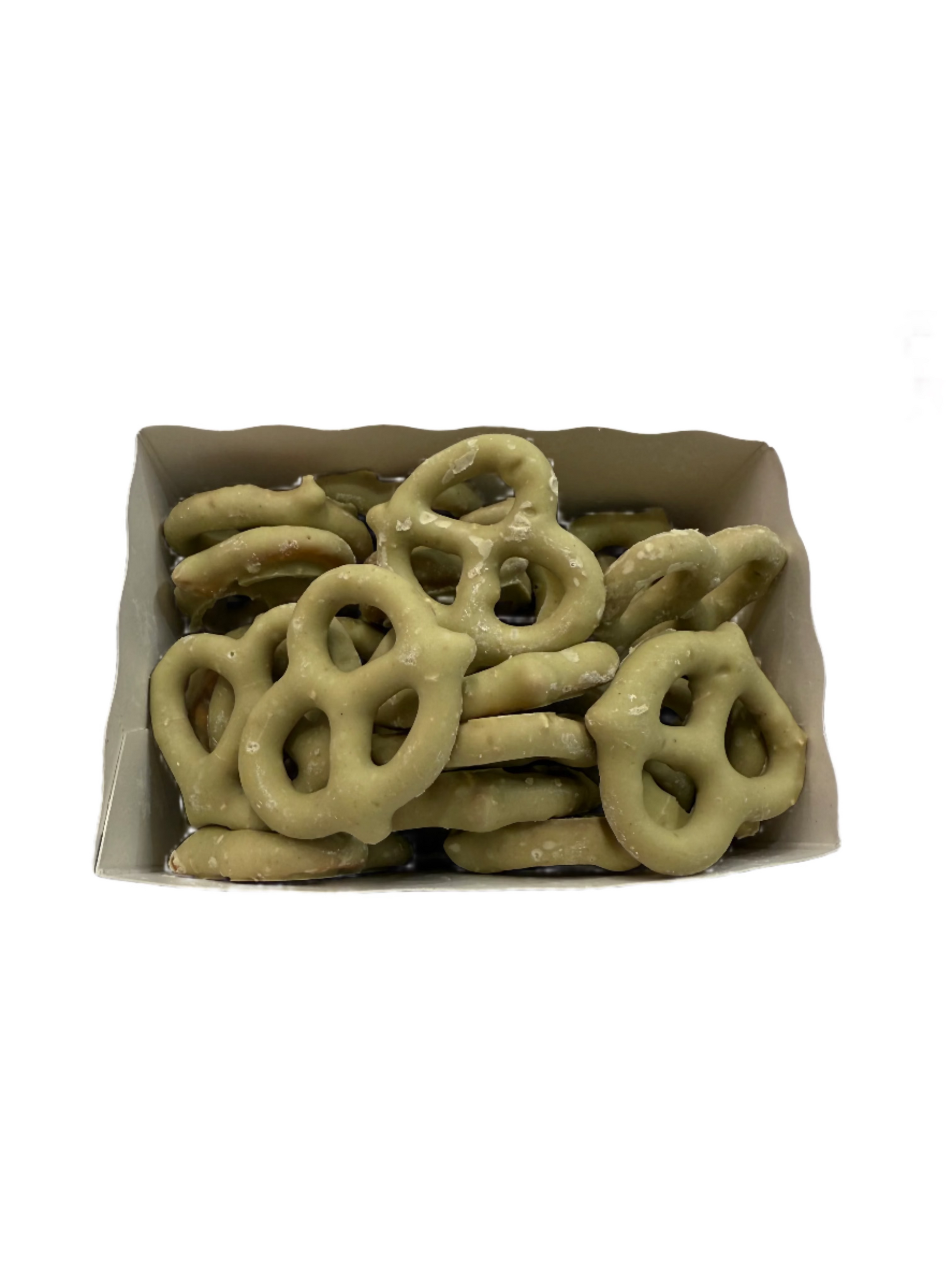 Box of green pretzels on a white surface with a blurred background